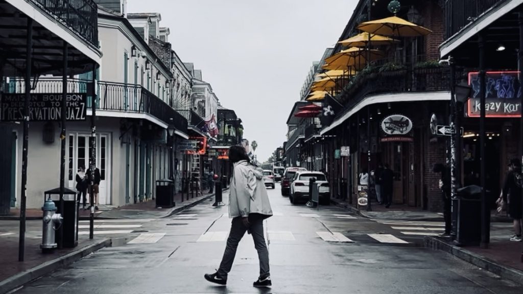 Man walking across Bourbon Street
